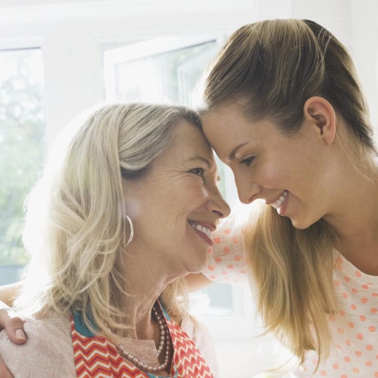 Affectionate mother and daughter in kitchen